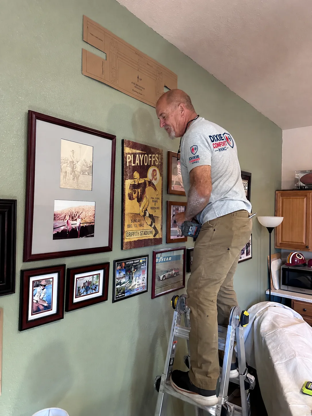 Paper mounting template taped to the cabin wall before a ductless mini-split indoor head is installed in Duck Creek Village, Utah