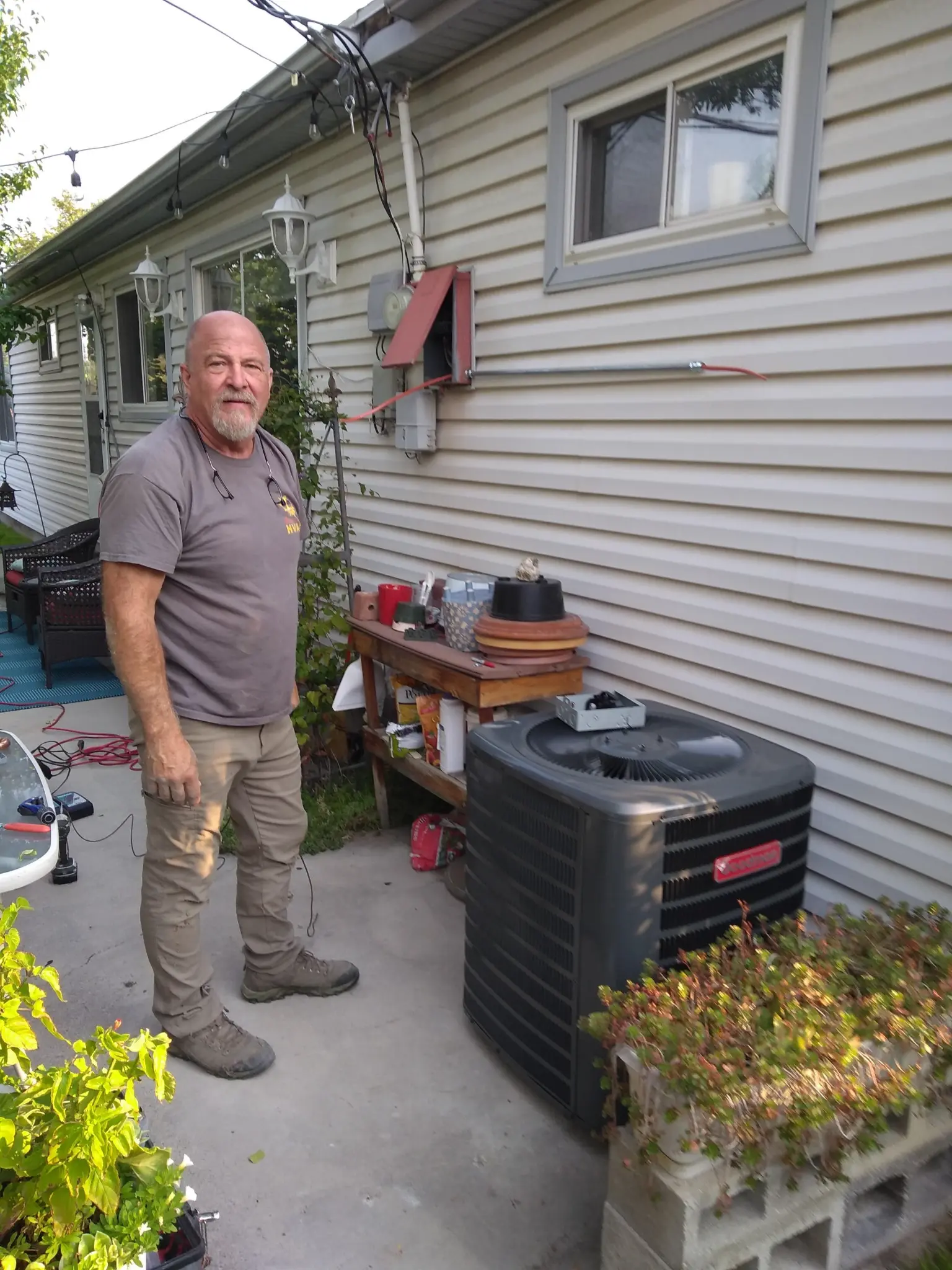 Bret Burgstrom evaluating an outdoor AC condenser at a residential home in St. George Utah